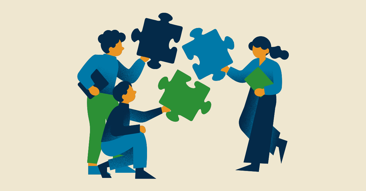 Illustration of three people collaboratively holding large blue and green puzzle pieces. They are working together, conveying teamwork and cooperation.